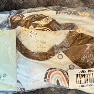 Short sleeve brown rainbow 3-6m button romper. Never opened